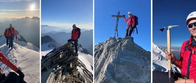 People in red jackets and helmets are climbing a snow-covered mountain with ice axes and ropes.