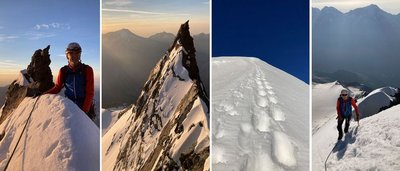Mountaineer with helmet and climbing gear on a snowy mountain peak at sunset.