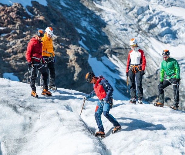 Mountaineers with crampons and ice axe on the glacier
