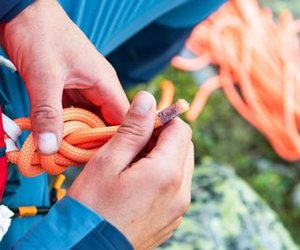 Climber ties a figure-eight knot in the rope