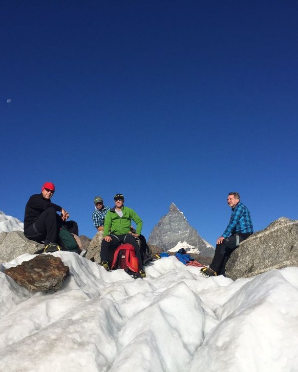 Glacier hikers take a break on the Gorner Glacier with the Matterhorn in the background.