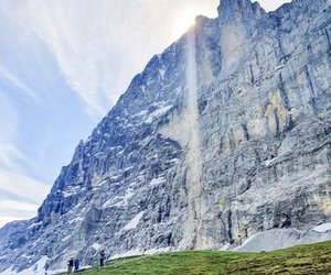 People below the north face of the Eiger on the way to the start of the via ferrata Rotstock