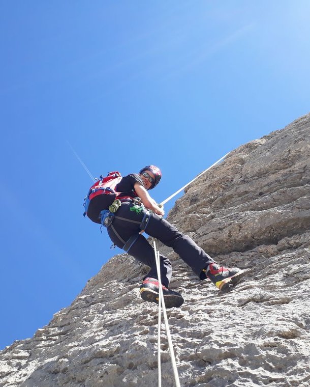 Climber rappels down