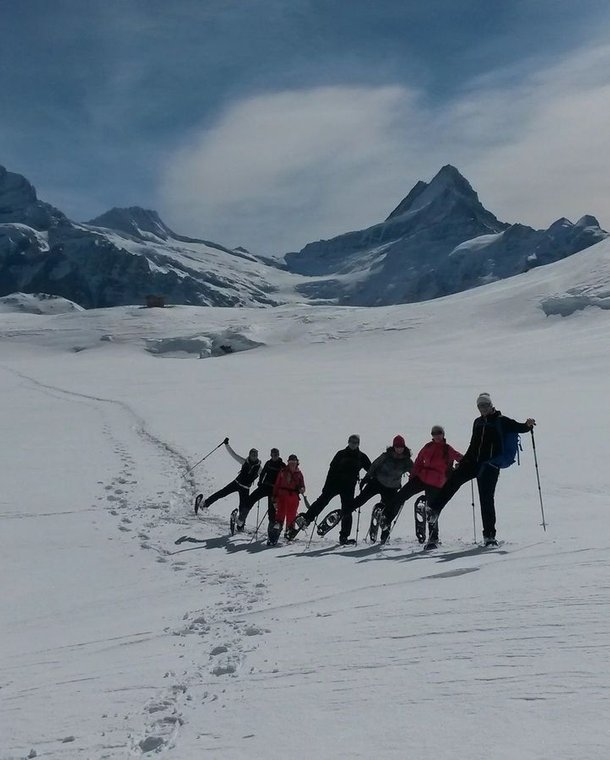 Group of snowshoe hikers at Bachalpsee on the way up to Faulhorn.