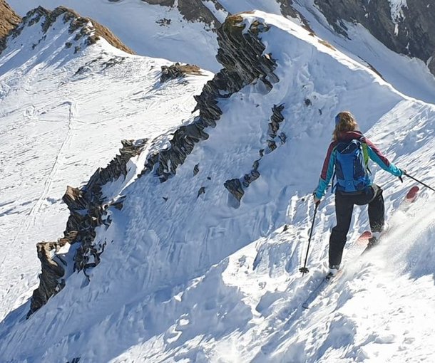 Ski tourer descent in steep slope