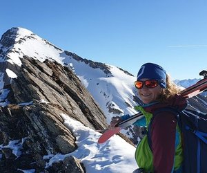 Ski tourers on a ridge with Schwarzhorn in the background.
