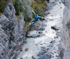 Person swings over river while Canyon Swing in Grindelwald